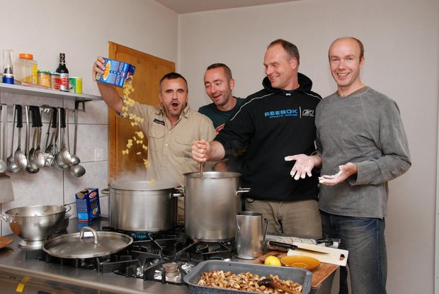 a cooking team at work 4 men at the cooker